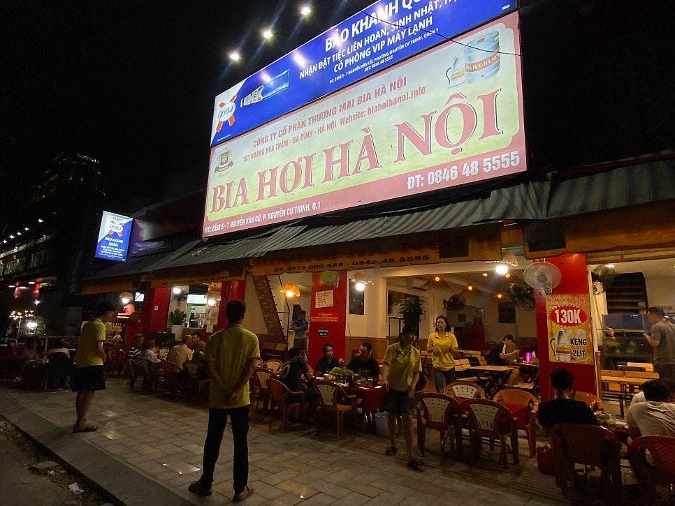 호치민 맛집 Bia hơi Hà Nội의 불 켜진 간판과 2리터 130K 배너
